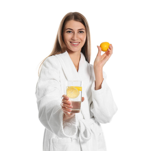 Young woman with glass of lemon water on white background - Foto, afbeelding