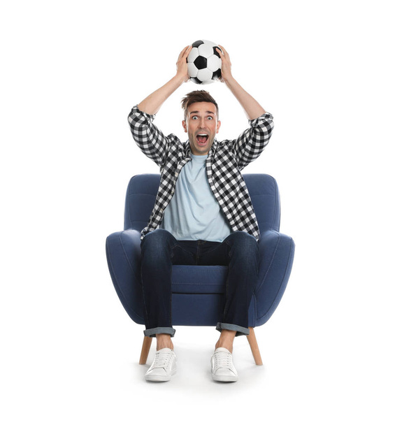 Handsome young man sitting in armchair and watching soccer match - Φωτογραφία, εικόνα