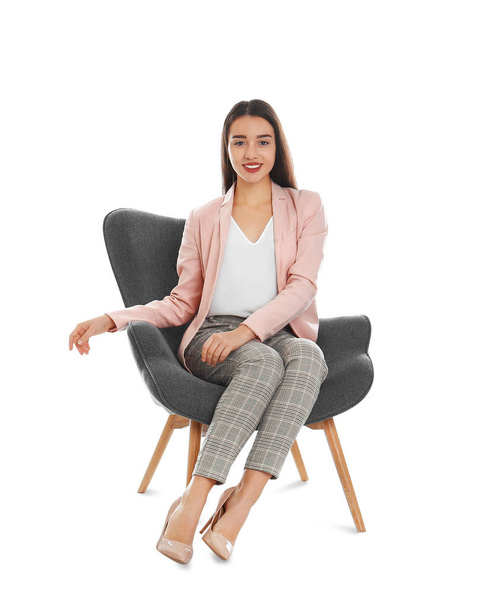 Young woman sitting in armchair on white background - Foto, Imagem