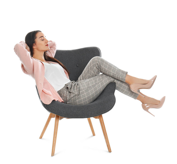 Young woman resting in armchair on white background - Photo, Image