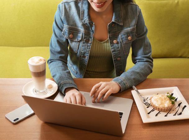 Blogger working with laptop in cafe, closeup - Valokuva, kuva