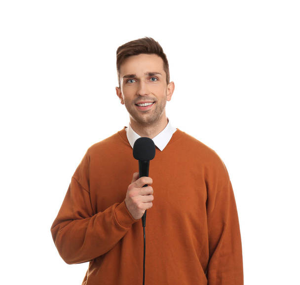 Young male journalist with microphone on white background - Photo, image