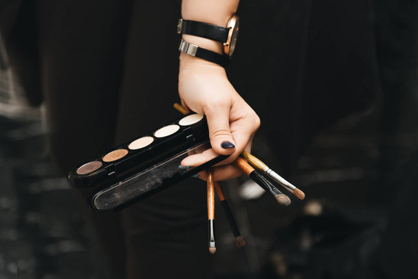 Set of makeup brushes in female hand on the background of eye sh - Фото, зображення