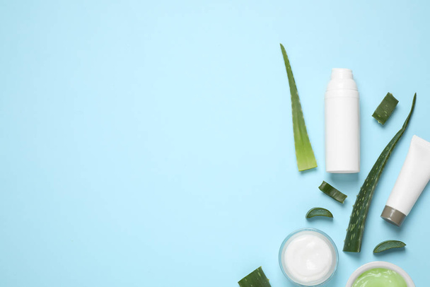 Flat lay composition with aloe vera and cosmetic products on light blue background. Space for text - Foto, Bild