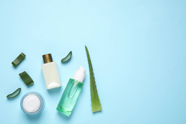 Flat lay composition with aloe vera and cosmetic products on light blue background. Space for text - Photo, image