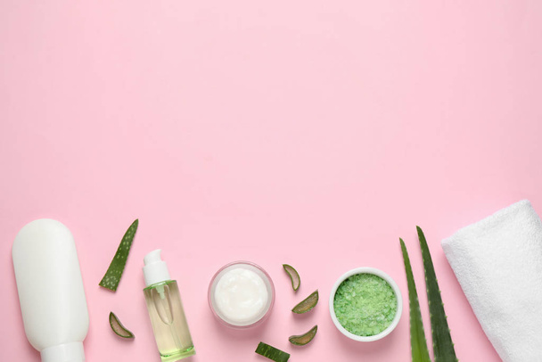 Flat lay composition with aloe vera and cosmetic products on pink background. Space for text - Фото, изображение