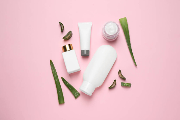 Flat lay composition with aloe vera and cosmetic products on pink background - Фото, зображення