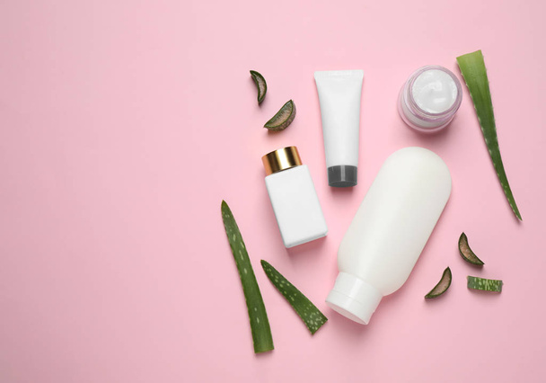 Flat lay composition with aloe vera and cosmetic products on pink background - Фото, изображение