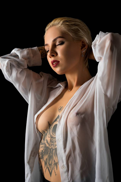 Tattooed blonde wearing unbuttoned shirt - Photo, image