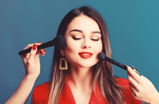 Pretty woman applying makeup brush. Perfect skin tone. Stunning beauty. Makeup supplies shop. Makeup courses. Gorgeous lady make up red lips. Skin care. Cosmetics concept. Beauty salon facial care - Photo, Image