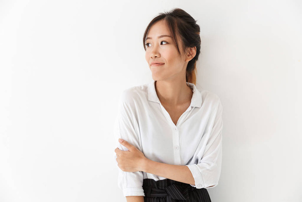 Attractive smiling asian woman standing isolated - Fotó, kép