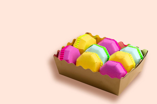 Різнокольорові паперові макаруни в подарунковій коробці
  - Фото, зображення