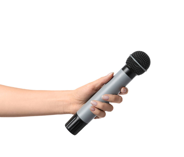 Mão feminina com microfone no fundo branco
 - Foto, Imagem