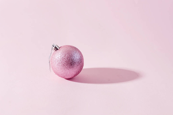 pink christmas balls on pink paper background - Fotoğraf, Görsel