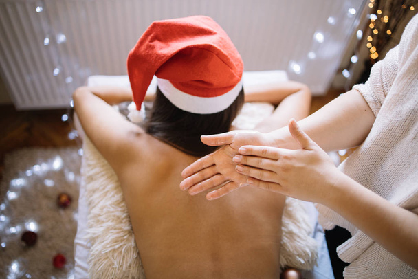 Top view of oiled masseuse hands over womans back - 写真・画像