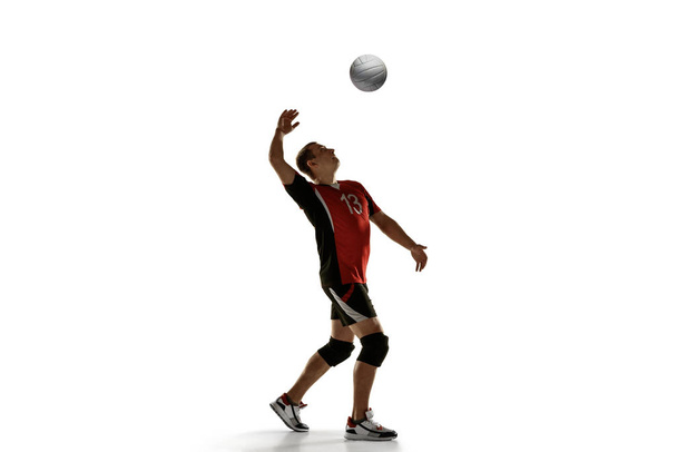 Young caucasian volleyball player placticing isolated on white background - Photo, Image