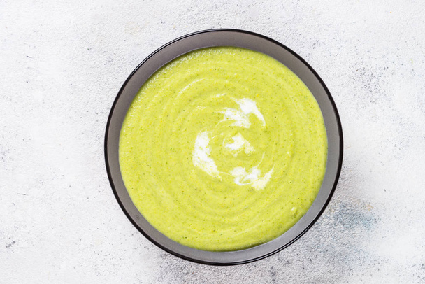 Broccoli cream soup in the bowl on white table. - Photo, Image