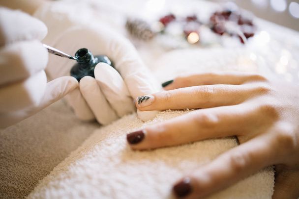 Close-up of manicurist doing a Christmas manicure - Photo, image