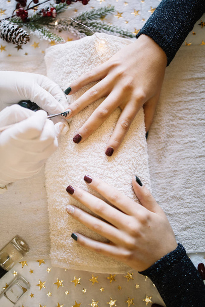 Top view of female hands with Christmas manicure - 写真・画像