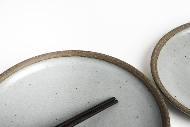 A Pair Of Chopsticks With Stoneware Plate - Φωτογραφία, εικόνα