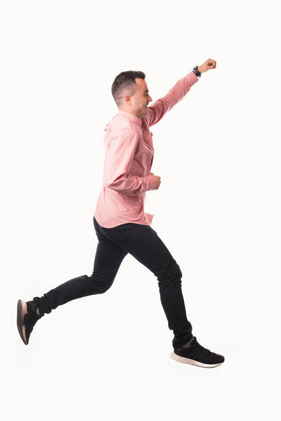 Photo of young man in red shirt jumping over white background - Photo, Image