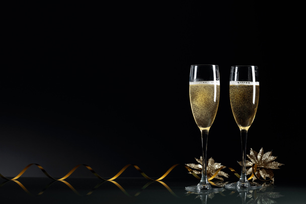 Two glasses of champagne ready to bring New Year on a black back - Photo, Image