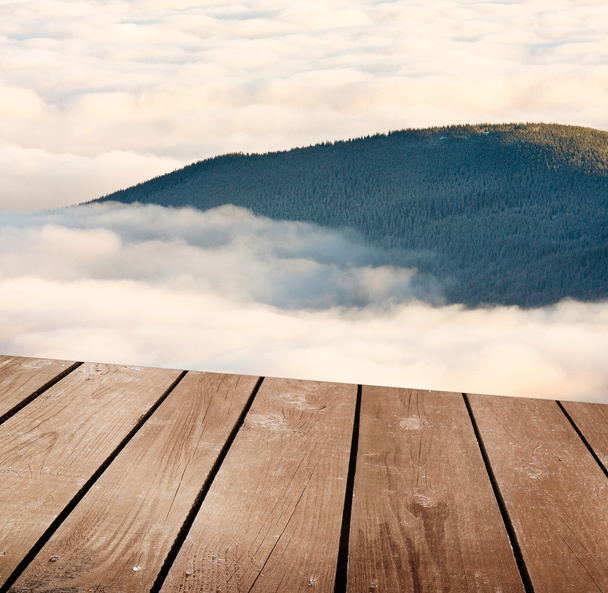 empty wooden deck table with clouds. Ready for product montage display. - Zdjęcie, obraz