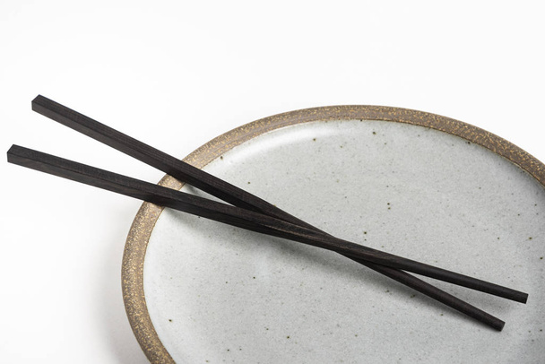 A Pair Of Chopsticks With Stoneware Plate - Photo, Image