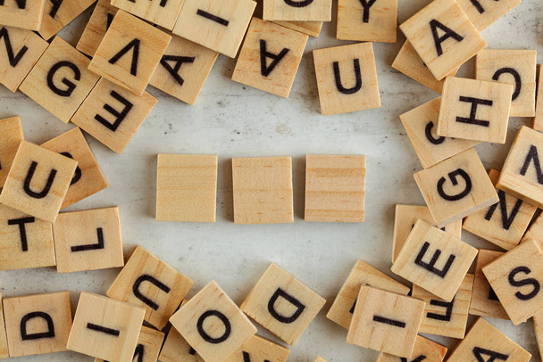 Top down view, pile of square wooden blocks with letters on whit - Foto, Imagem