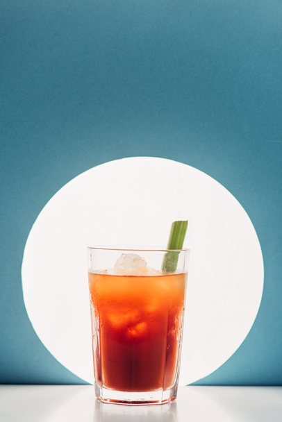 bloody Mary with celery on blue background with back light - Photo, Image