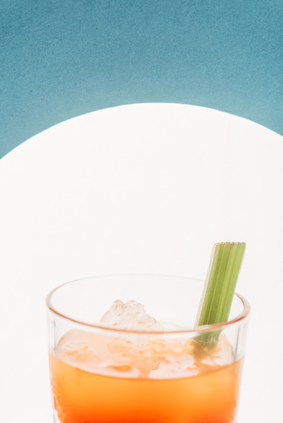 close up view of bloody Mary with celery on blue background with back light - Photo, Image