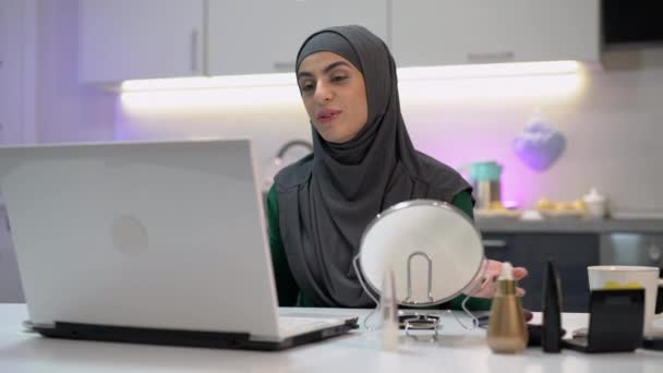 Happy Arabic girl smiling and talking on laptop camera, freelance job, blogging - Filmati, video