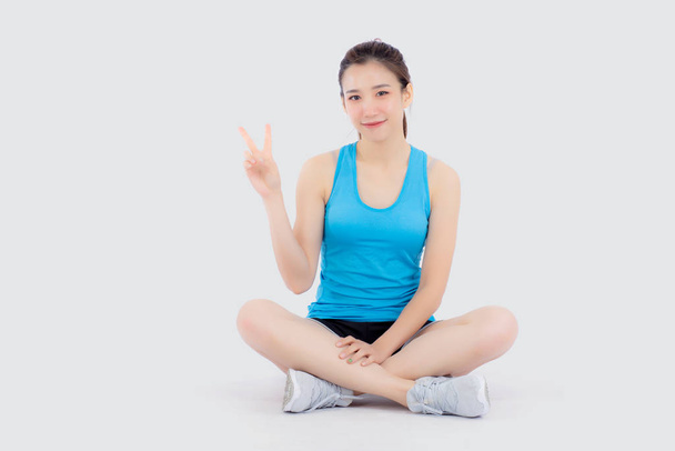 Female Asian in sports attire doing stretching exercise Stock Photo