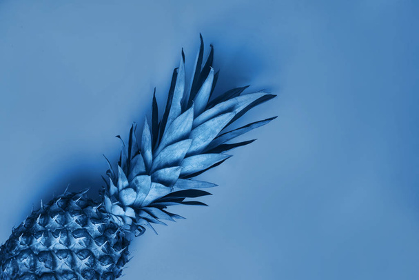 Pineapple with copy space, blue toned photo. - Фото, изображение