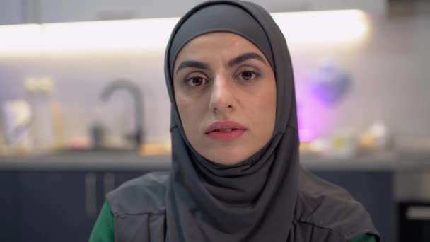 Sad muslim woman looking at camera, feeling helpless in world of stereotypes - Footage, Video