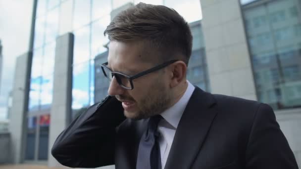 Male entrepreneur in glasses suffering neck pain, muscle spasm, inflammation - Séquence, vidéo