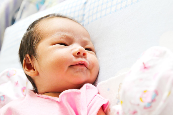 Newborn Asian baby girl lies on a blanket - Φωτογραφία, εικόνα