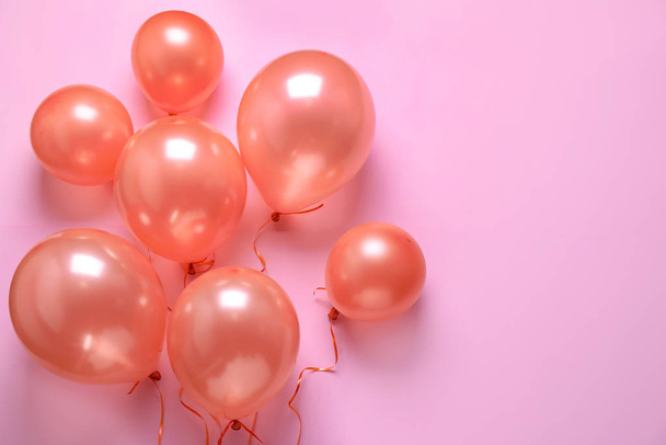 Colorful balloons on pink background, flat lay. Space for text - Фото, зображення