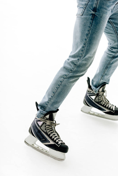 cropped view of man in jeans and skates skating on rink - Foto, immagini