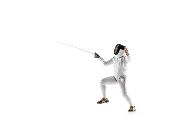 Teen girl in fencing costume with sword in hand isolated on white background - Photo, image
