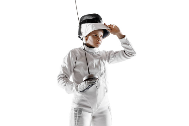 Teen girl in fencing costume with sword in hand isolated on white background - Foto, Imagen