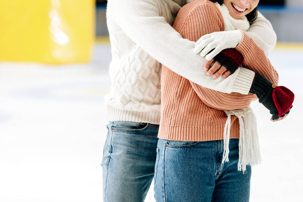 cropped view of young couple hugging on skating rink   - Photo, Image