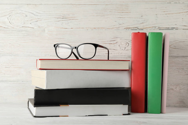 Books and glasses against wooden rustic background, space for te - Fotoğraf, Görsel