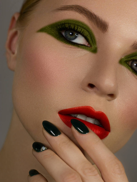 Half Beautiful close up sexy young woman evening make up dark eye eyelashes dyed and green liner, makeup artist cosmetic beauty salon spa. Long green nails, clean skin and red nude lipstick. - Foto, Imagem