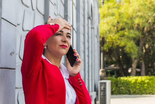 Деловая женщина разговаривает по телефону на улице
.  - Фото, изображение