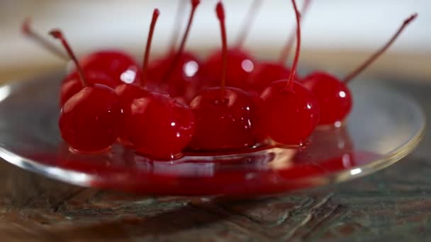 Candied cherry with sprigs in a glass plate spin on a stand - Footage, Video