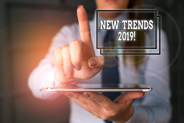 Word writing text New Trends 2019. Business concept for general direction in which something is developing Blurred woman in the background pointing with finger in empty space. - Photo, Image