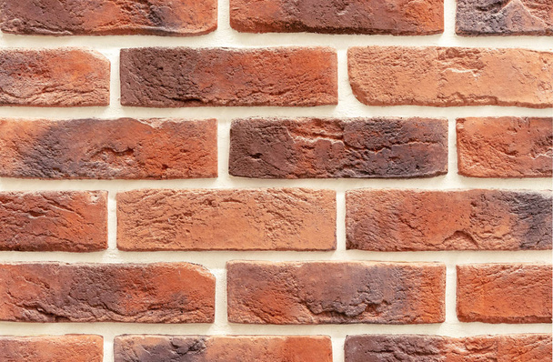Brick wall of red and brown bricks. Background and texture of brickwork. - Photo, Image