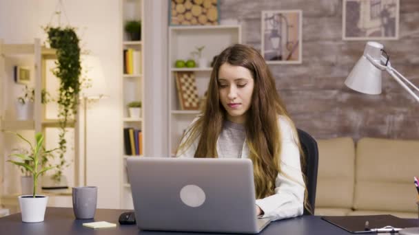 Girl working on laptop from home office - Materiał filmowy, wideo