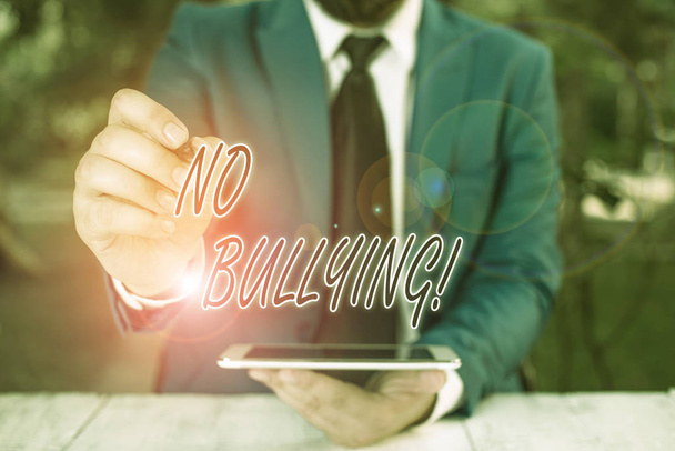 Word writing text No Bullying. Business concept for stop aggressive behavior among children power imbalance Businessman pointing with pen in empty copy space. - Photo, Image